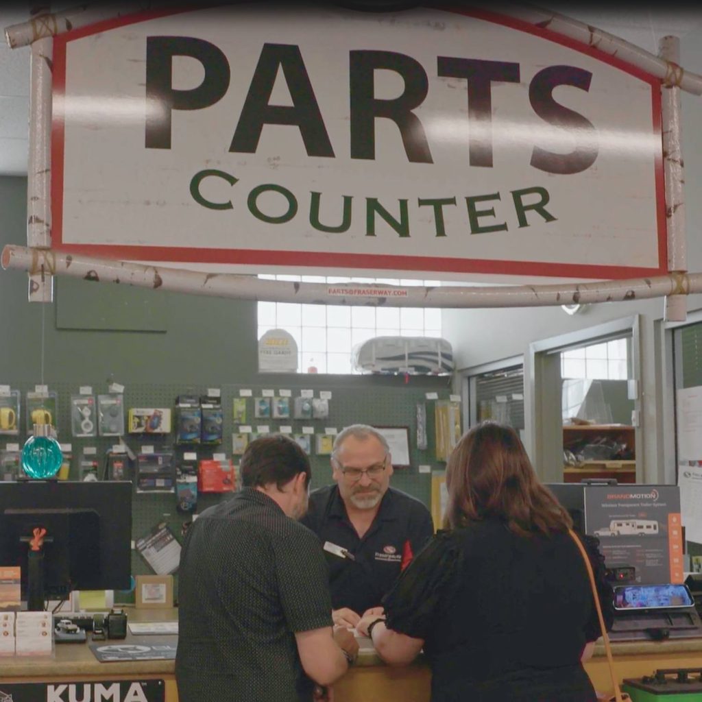 Fraserway RV Parts experts helping customers at till choose a part